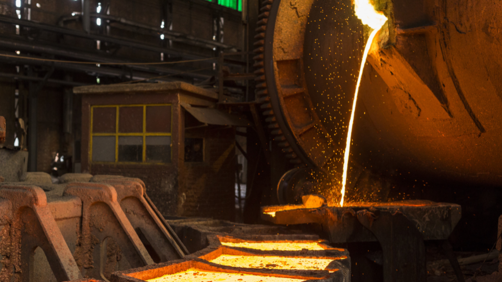 Molten copper pouring from a smelter furnace into casting moulds